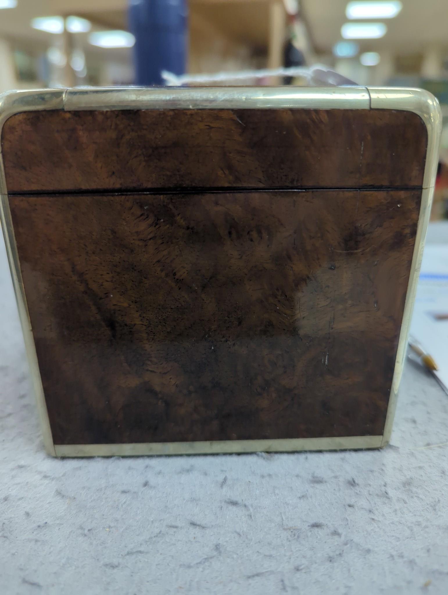 A 19th century Dutch amboyna and brass mounted tea caddy, 14 cm wide and a 19th century French mahogany box by Aucoc Aine a Paris